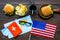 Gastronomical tourism with american flag, passport, tickets, map, burgers, chips, drink on wooden background top view