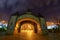 A gate of a distraction park at night colorful with lights at night.