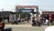 Gate of distric head hospital sundargarh  in city road area & both side shop  bike with peoe