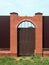 Gate in fence with brick pillars