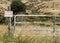 Gate and Fence on Rolling Hillside in Rural America