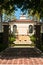 Gate open view, far distance of front of a tropical, beach mansion