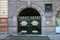 Gates of military department in dark black with gold stars on it and plaque with inscription Monument of architecture