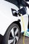 Gateshead UK: A hand-held closeup of an electric BMW car on charge EV, green sustainable travel