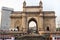 The Gateway of India and boats in the background Taj Mahal Hotel, Mumbai, India.