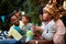 Gathered family spending time together, playing with paper boats, talking, smiling, having fun. Family, togetherness