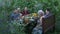 Gathered together relatives and friends at picnic outdoor. Young and elderly relatives eating and drinking at dining table on cour
