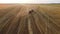 Gathering stacks of straw in wheat harvest field, loading on truck, transporting