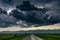 Gathering storm clouds over green agricultural fields