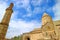 Gavazan Seismographic Pillar with Church of St. Paul and Peter against Blue Cloudy Sky, Tatev Monastery, Armenia