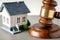 gavel closeup, striking down near a small house model real estate law