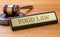 A gavel and a name plate with the engraving Food law