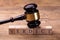 Gavel Over Wooden Blocks With Text Verdict