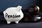 Gavel and piggy bank with sign pension. Legal and law.