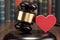 Gavel and red heart on table