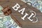 Gavel, Sign BAIL, Handcuffs And Dollar Cash On Wood Background