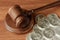 Gavel with silver dollars on a wood surface