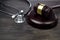 Gavel and stethoscope on black wooden background