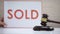 Gavel striking sound block against sold sign background, court decision, auction