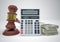 Gavel, wads money and calculator