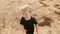 Gay boy kid blonde running on the beach