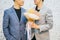 Gay couple holding a bouquet of flowers, ready to give to his partner for special occasions or wedding proposal.