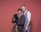Gay couple photo-shoot in studio, holding a puppy in arms