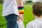 Gay father holding his son`s hand in a park. Parental concept and equality