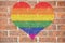 Gay heart on brick wall