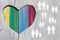 Gay and lesbian couples and families on wooden background with multicolor rainbow heart