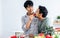 Gay LGBT sweet Asian couple wearing pajamas, smiling with happiness and love, eating, feeding watermalon, healthy fruits for