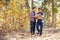 Gay Male Couple With Baby Walking Through Fall Woodland