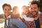 Gay Male Couple With Children Walking By Lake