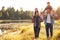 Gay Male Couple With Children Walking By Lake