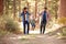 Gay Male Couple With Daughter Walking Through Fall Woodland