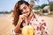 Gay man enjoys fresh coconut drink on sunny beach. Smiles, relaxed pose, tropical vacation vibe. LGBT travel lifestyle