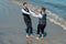 Gay man with partner on wedding day. Gay grooms walking together on sea beach during Wedding day. Romantic men in sea