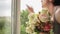 A gay man receives a gift of a bouquet of flowers, rejoices