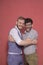 Gay men acting silly, hugging together