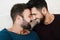 Gay men couple having tender moment together at home - Homosexual, multiracial love and relationship concept - Main focus on left