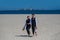 Gay men walking on a beach. Lgbt gay marriage couple having romantic moment together after wedding ceremony. Concept of