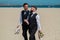 Gay with partner with care and love. Gay couple holding bouquet together during wedding ceremony. Gay grooms walking
