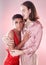 Gay, portrait and people hug isolated on pink background in beauty glow, pastel and creative art aesthetic. Fashion