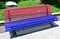 Gay pride bench at public park. Colours of bisexual pride flag. A CoruÃ±a, Galicia, Spain.