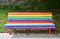 Gay pride bench at public park. Colours of gay rainbow flag. CamariÃ±as, Galicia, Spain.