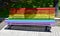 Gay pride bench at public park. Colours of gay rainbow flag. A CoruÃ±a, Galicia, Spain.