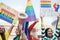 Gay and transgender people protest at pride event outdoor- Lgbt and equality rights concept - Focus on hand holding megaphone