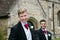 Gay wedding, grooms leave village church after being married with big smiles and holding hands