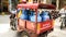 Gaz cylinders transported in a red tuk tuk in Macau by a delivery service