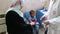 Gaza city, a young child being vaccinated attended to by a doctor in a hospital